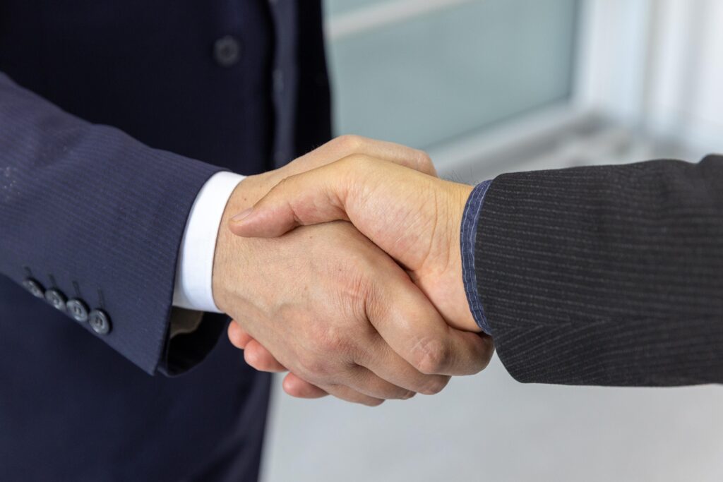 Two professionals shaking hands in a business setting