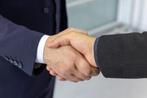 Two professionals shaking hands in a business setting